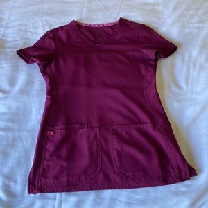 Maroon scrubs shirt and cuffed scrubs bottoms